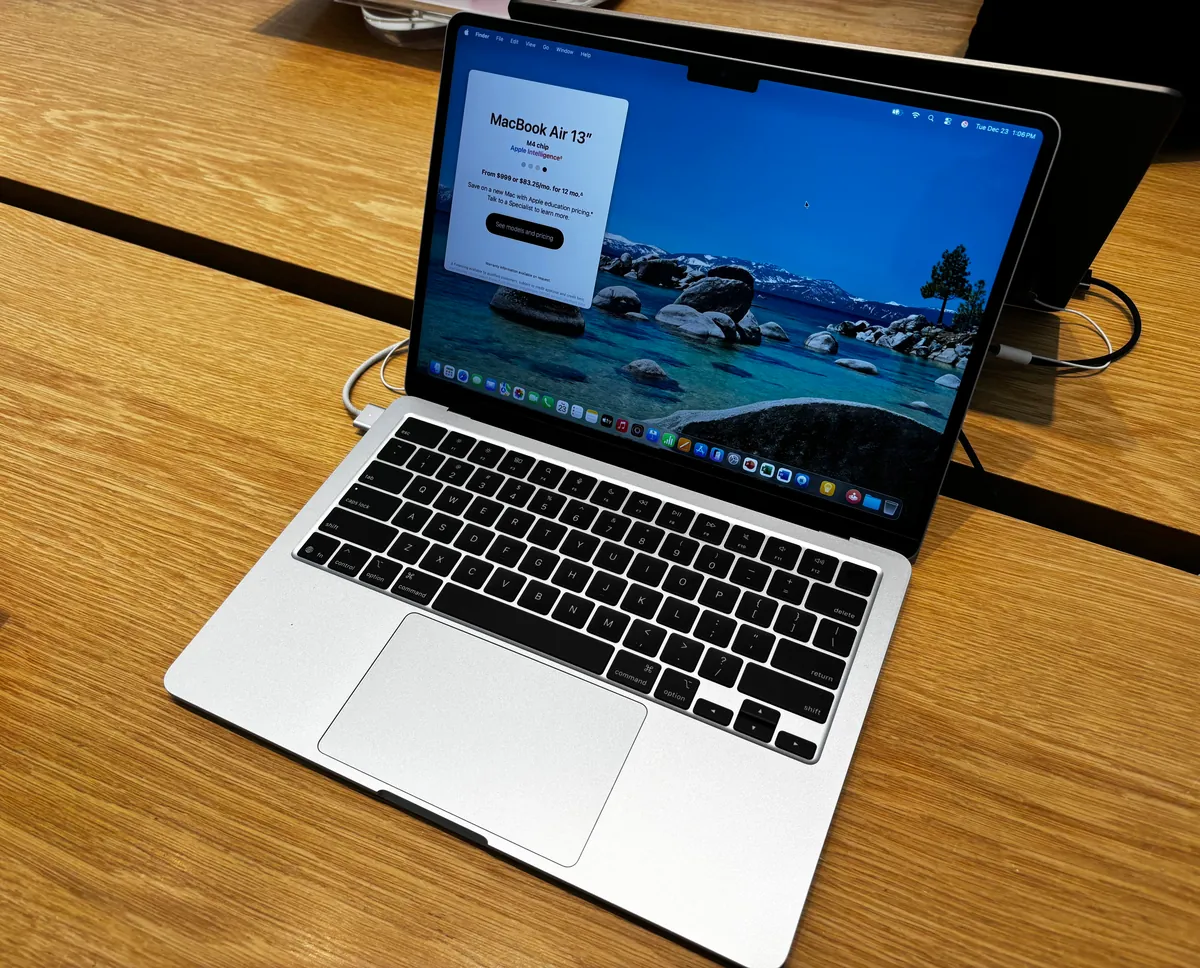 13-inch MacBook Air (M4) in Silver, open on a wooden table, front three-quarter view